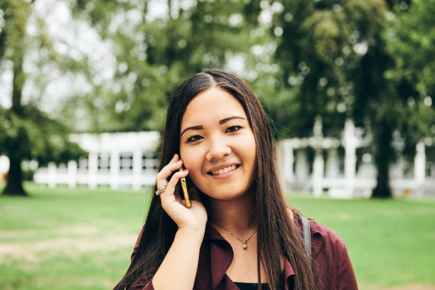 istock Friendly Asian woman talking on smartphone 1275629584