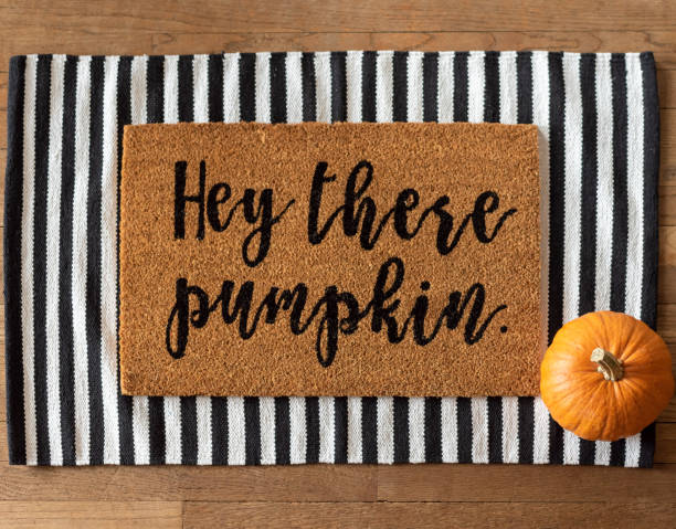istock Stylish fall doormat and a pumpkin 1275645899