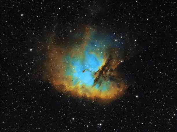 The Pacman Nebula (NGC 281) is a bright emission nebula and H-alpha region located in the constellation Cassiopeia, 9500 light years away from Earth. Amateur picture taken with professional CMOS camera and refractor telescope (800mm, f/6.95), image consists of: Ha: 72 x 300s, OIII: 55 x 300s, SII: 83 x 300s. Total exposure time: 10,5h, HSTpalette image.