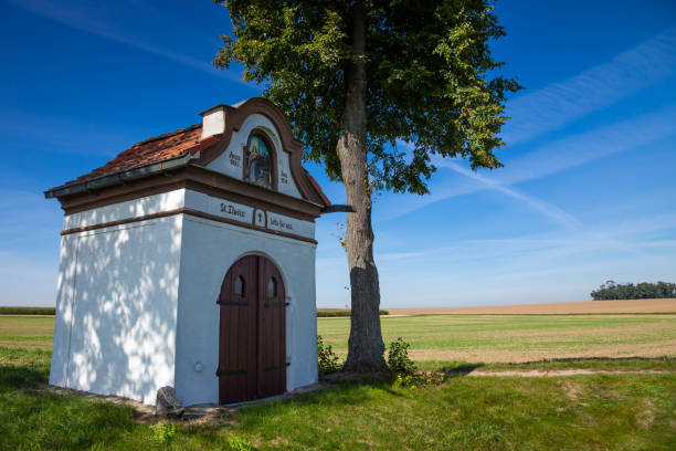istock small chapel (roadside shrine) next to the road. 1275660647
