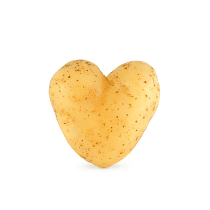 Natural organic heart shaped potato isolated on white background