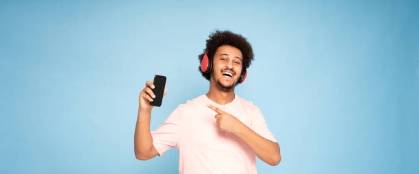 istock African guy showing mobile phone. 1275674994