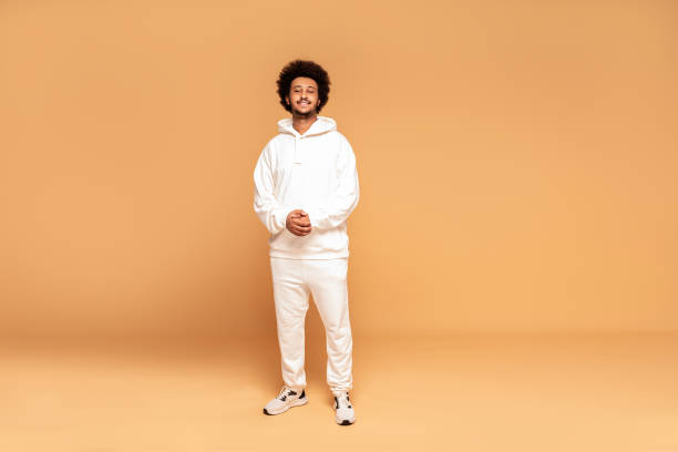 Fashionable afro man in tracksuit. Studio shot of young handsome African man wearing fashionable tracksuit. tracksuit stock pictures, royalty-free photos & images