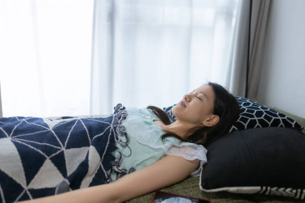 istock Young woman sleeping on bed in the morning 1275676041