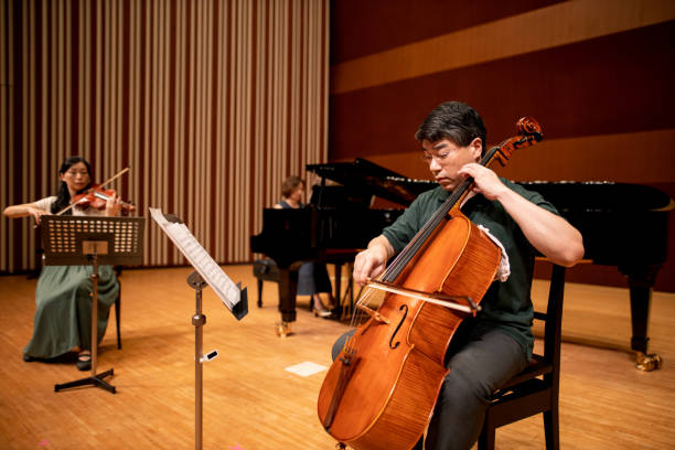 istock Musician playing violin, cell, and piano at classical concert 1275677050