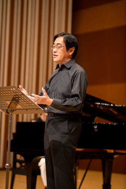istock Man singing a song at classical concert with piano 1275677057
