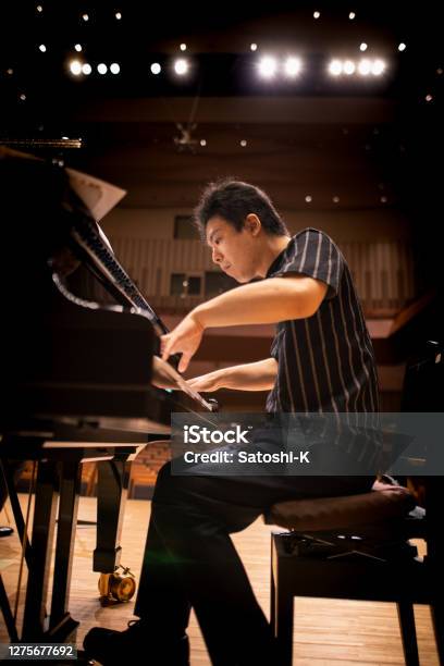 Pianist Playing The Piano At Concert Hall Stock Photo - Download Image Now - Piano, Orchestra, Musician