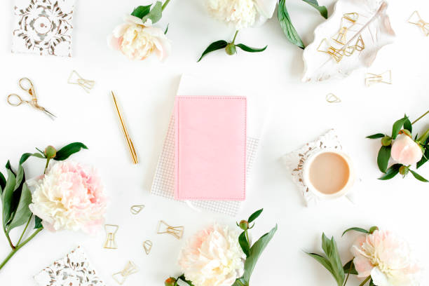 istock Workspace with diary, notebook, accessories, peony flowers on white background. Home office desk. Top view feminine background. Flat lay, top view 1275677917