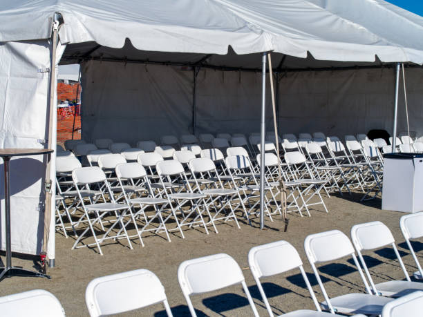 istock Plastic chairs under a tent set up for a special event meeting. 1275678537