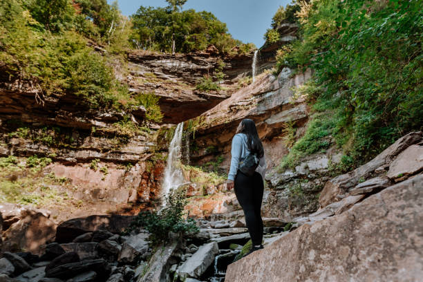 istock Friends hiking on the mountain with waterfall 1275679561