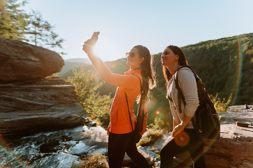 Friends hiking on the mountain with waterfall