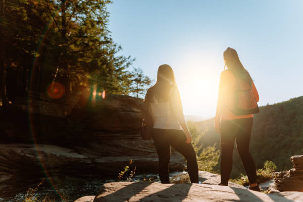 istock Friends hiking on the mountain with waterfall 1275679641