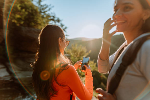 istock Friends hiking on the mountain with waterfall 1275679679