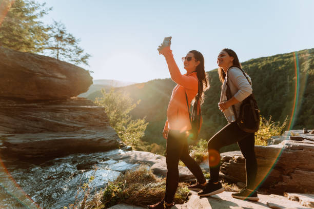 istock Friends hiking on the mountain with waterfall 1275679681
