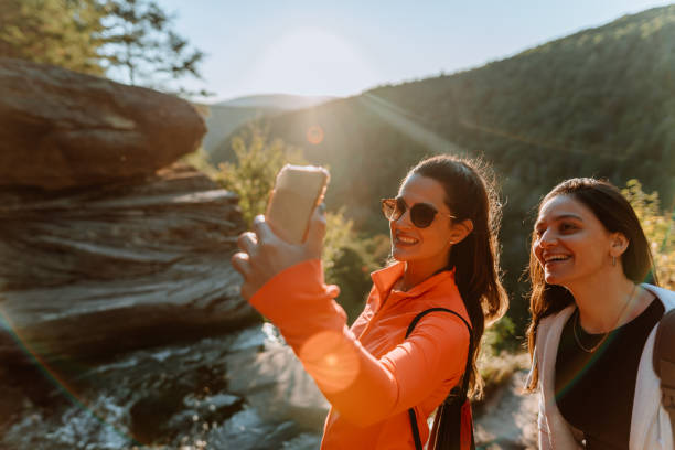 istock Friends hiking on the mountain with waterfall 1275679687
