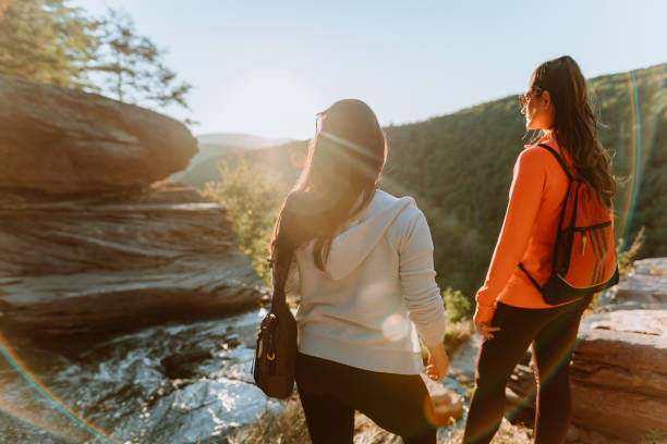 istock Friends hiking on the mountain with waterfall 1275679751