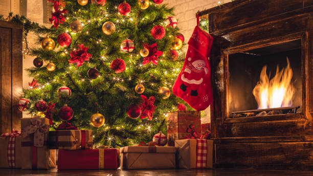 Decorated Christmas Tree Near Fireplace at Home Christmas tree near fireplace in decorated living room red poinsettia vibrant color flower stock pictures, royalty-free photos & images