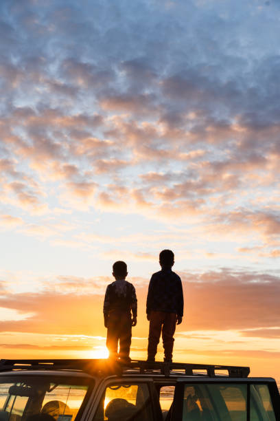 istock Kids enjoying sunset at beach. 1275681173