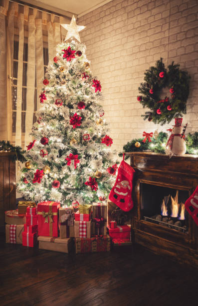 Decorated Christmas Tree Near Fireplace at Home Christmas tree near fireplace in decorated living room poinsettia christmas candle flower stock pictures, royalty-free photos & images