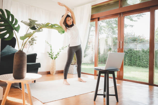 istock woman learned online workout excercise class at home from laptop 1275682262