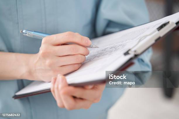 A Japanese Female Worker At Hand Inspecting A Houses Equipment Stock Photo - Download Image Now