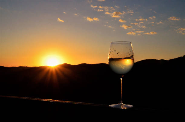 istock Sun and sky reflected in wine glass in late afternoon 1275685631
