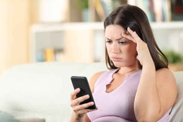 istock Frustrated woman checking phone finding mistake 1275685646