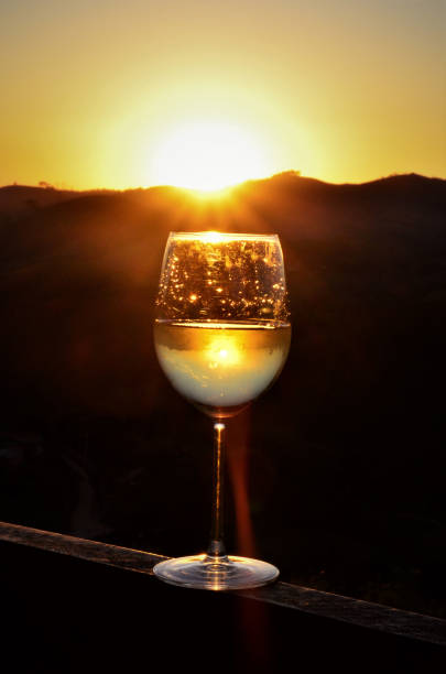 istock Wine glass reflecting the beautiful sunset in the mountains 1275685695