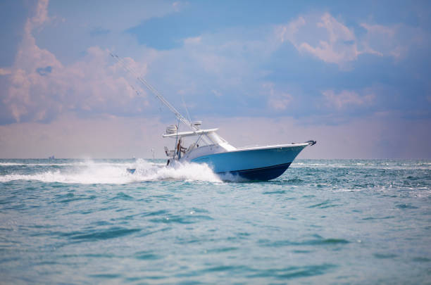 Summer vacations: Friends diving from a yacht sailboat at sea