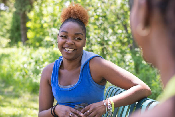 istock Two African American women resting on a bench after exercising 1275707993