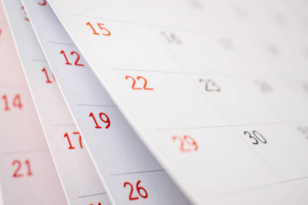 istock Calendar page flipping sheet close up on office table background business schedule planning appointment meeting concept 1275708040