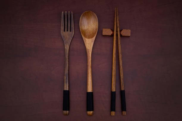 istock Wooden spoon, fork and chopsticks on wooden table 1275711928