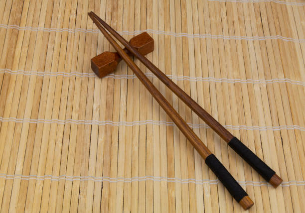 istock Wooden chopsticks on bamboo mat 1275712575