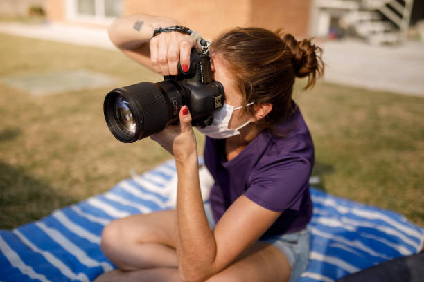 istock Female photographer wearing mask 1275716310