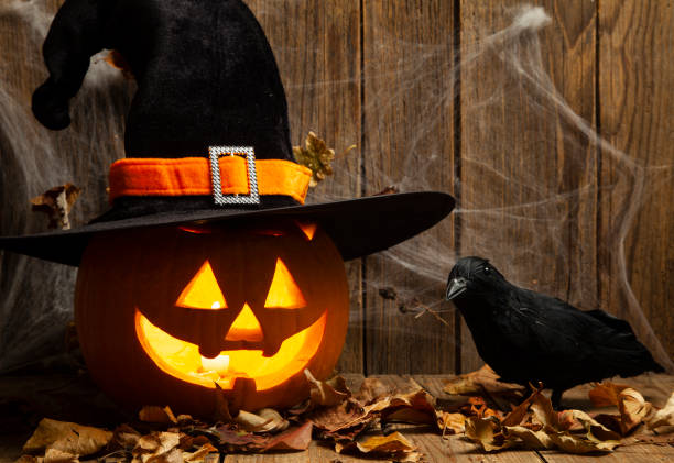 istock Halloween Jack-o-Lantern Pumpkins on rustic wooden background 1275725195