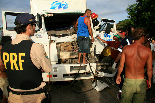 eunapolis, bahia / brazil - january 28, 2009: people come to the rescue of a truck driver trapped in the hardware during an accident on the BR 101 highway, in the city of Eunapolis, in southern Bahia.