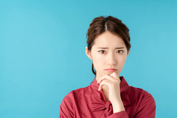 istock Thinking asian woman. 1275737349