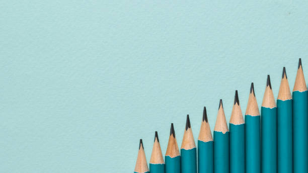 istock Graphite pencils laid in the form of steps on a blue background. 1275742415