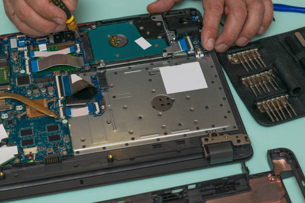 istock A man is replacing a hard drive on a laptop. 1275742459