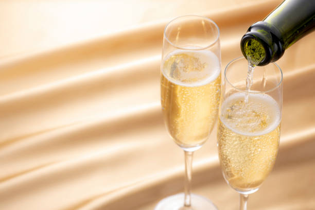Champagne and a glass on the tablecloth Champagne and a glass on the tablecloth champagne stock pictures, royalty-free photos & images