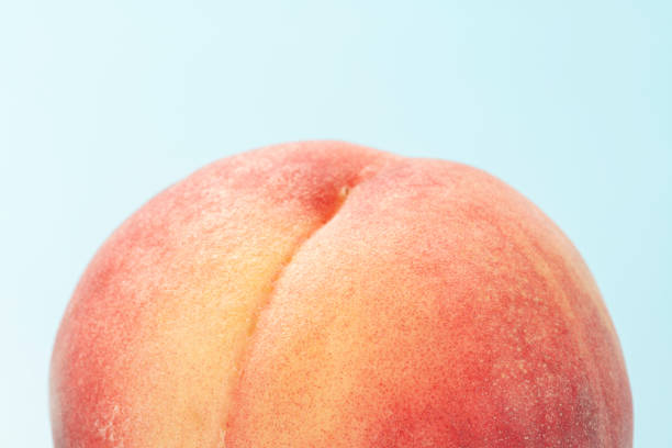Peach on a light blue background. Summer fruits.