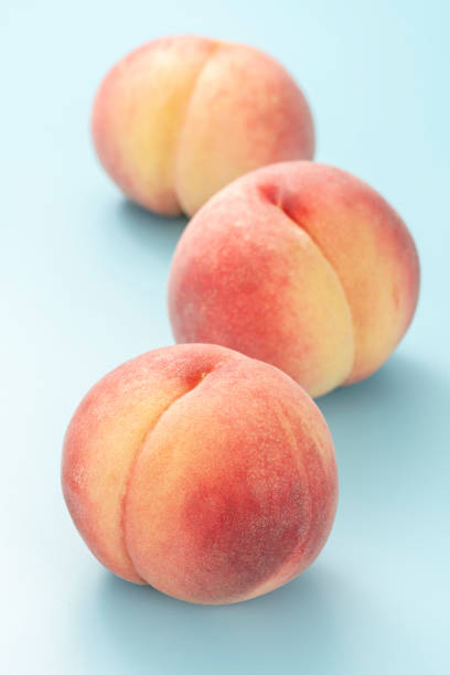 istock Peach on a light blue background. Summer fruits. 1275744943