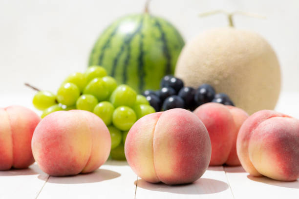 Summer fruits on a white board.