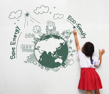 Girl holding a paint brush painting on a white wall with creative drawing eco friendly, save energy