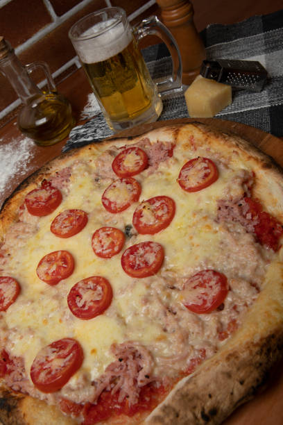 istock Italian pizza sliced ham, mozzarela cheese and tomatoes 1275745239