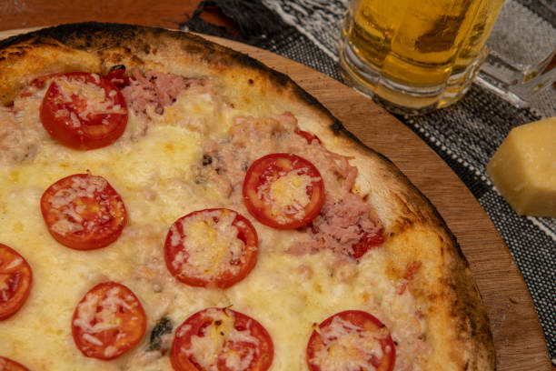 istock Italian pizza sliced ham, mozzarela cheese and tomatoes 1275745336