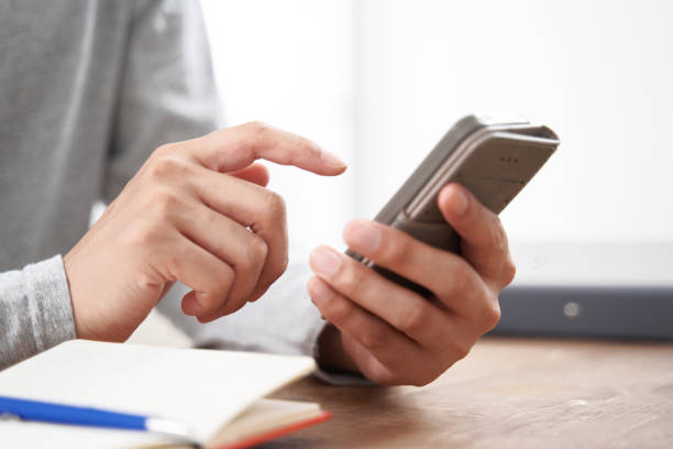 Japanese man at hand using a smartphone