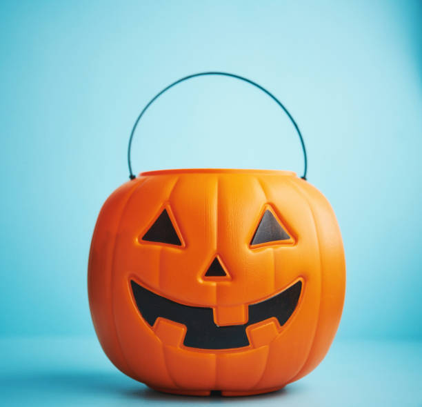 Halloween background with smiling Jack O'Lantern bucket