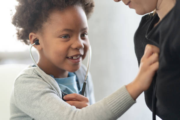 istock Young girl using stethoscope on adult 1275749195