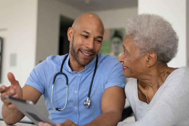 istock Male nurse visits elderly patient in residence 1275749196